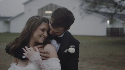 Cinematic embrace beneath a barn at twilight