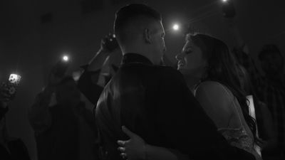 Bride and groom share a first dance in black and white