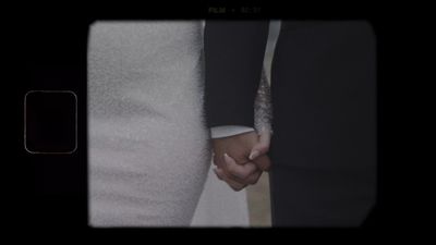 Bride and groom holding hands, vintage film detail