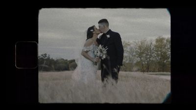 Bride and groom kiss in a field, vintage film portrait