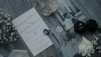 Wedding invitation flatlay with vintage rings and photos