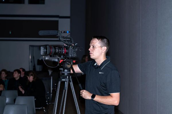 Wesley Blalock operating a Canon cinema camera at an event